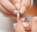 Stylistka nakłada produkt podczas manicure w salonie